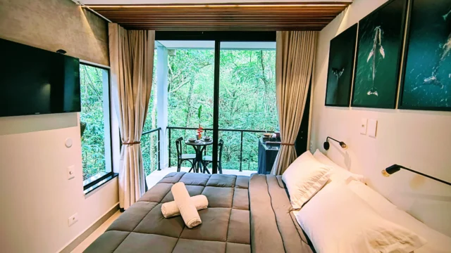 Quarto com cama confortável e vista para a floresta — acordar na Siriúba é desacelerar.