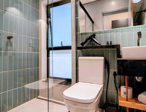 Banheiro moderno e super bem cuidado, com box de vidro e acabamento clean — perfeito para relaxar depois da praia e da cachoeira.